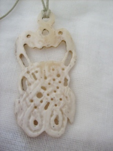 Bone pendant featuring knotwork
